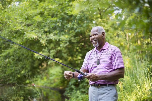 Man Fishing Wearing On the Go medical alert system with fall detection