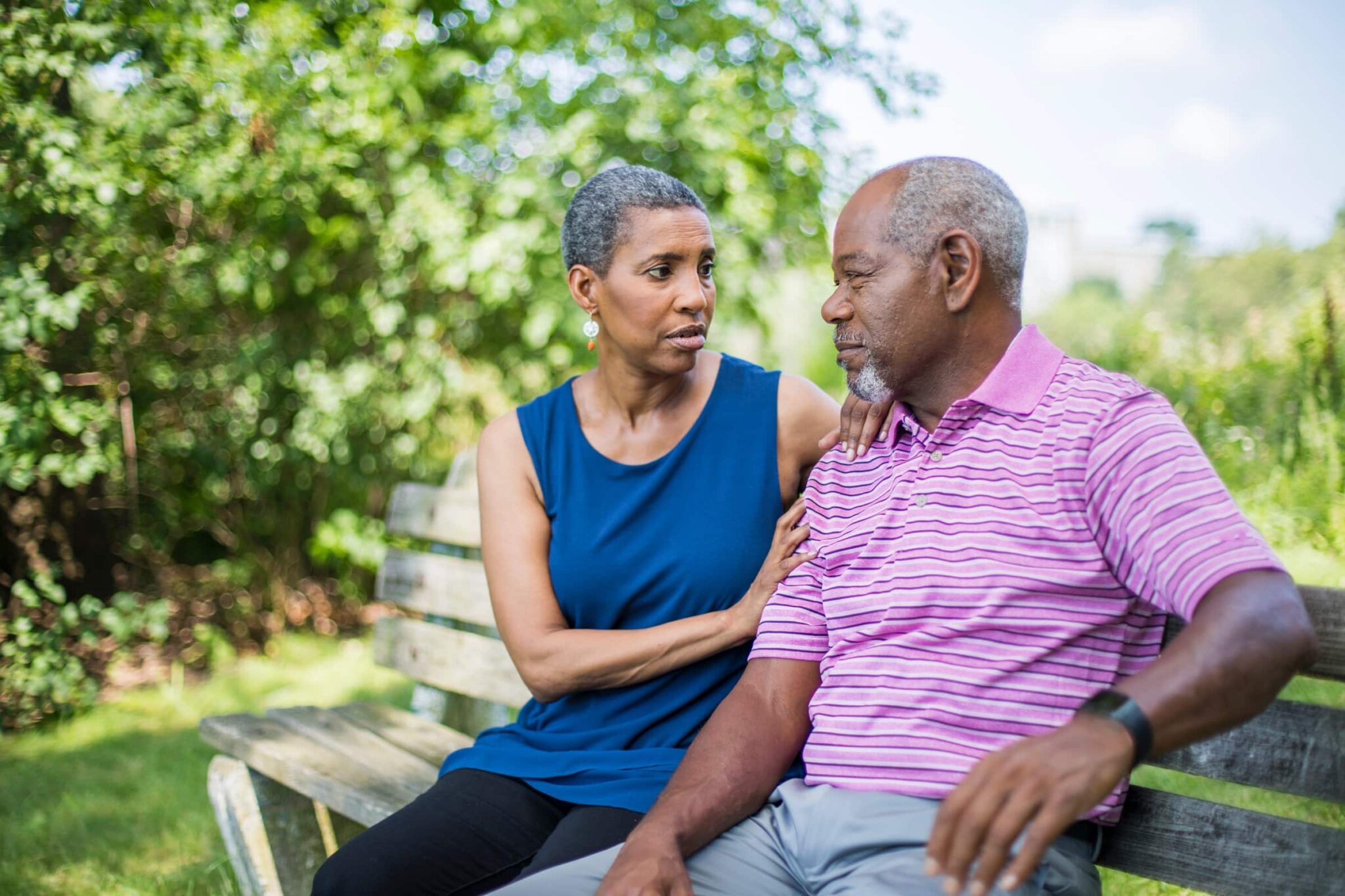 Elderly man and woman sitting on bench