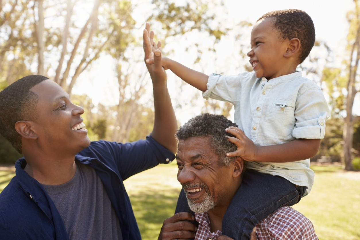 Grandfather With Son And Grandson Having Fun In Park