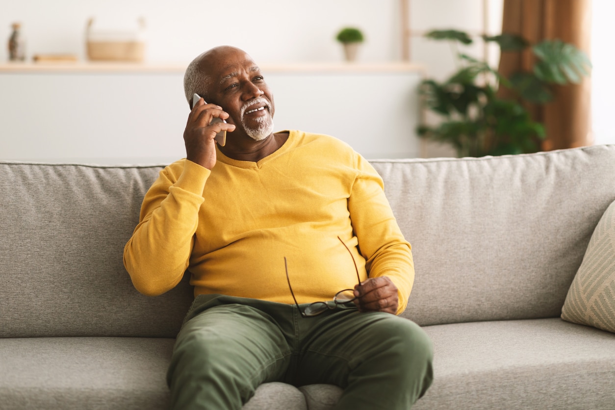 Man on couch on the phone